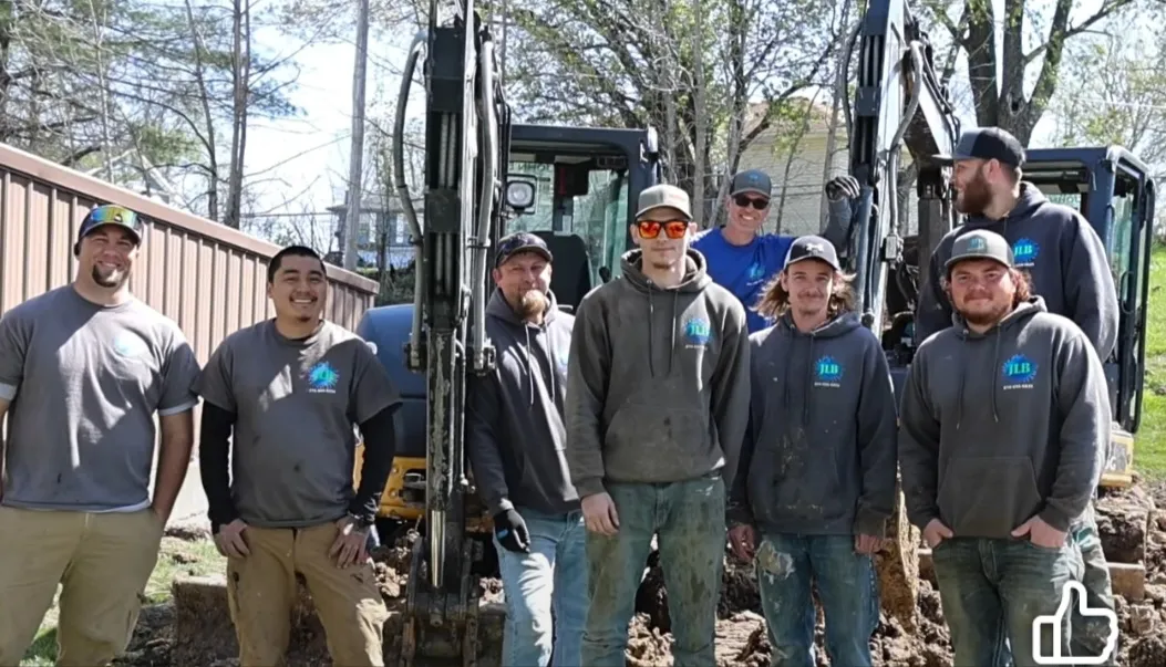 Full team photo of JLB Foundation Repair crew with excavators behind them