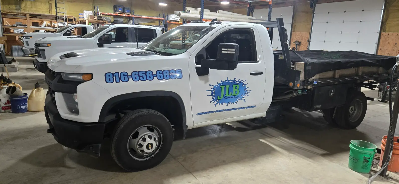 JLB branded truck fleet in warehouse — serving Des Moines, IA area